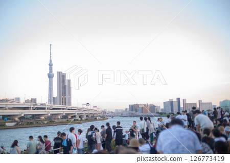 [Japan] Crowds waiting for the 46th Sumida River Fireworks Festival to begin at the riverbed of Shioiri Park in Arakawa Ward, Tokyo, and evening scenery 126773419