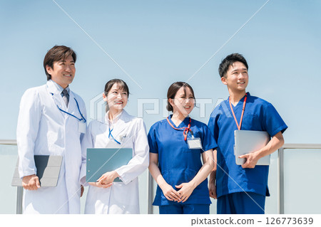 Male and female doctors, nurses, medical staff and technicians (4 people) on the roof of a hospital 126773639