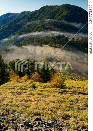 Morning mist flows through Okamidaira and Mt. Koganezawa as seen from Mt. Tengudana in the Daibosatsu mountain range Morning mist flows through Okamidaira and Mt. Koganezawa as seen from Mt. Tengudana in the Daibosatsu mountain range 126773895
