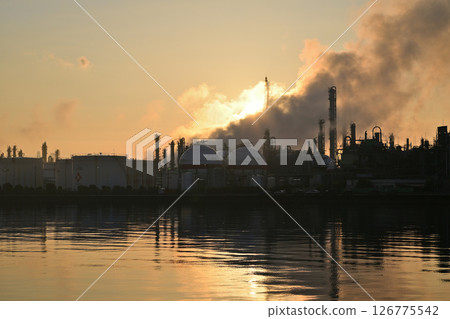 Factory chimneys reflected on the water Factory chimneys reflected on the water 126775542