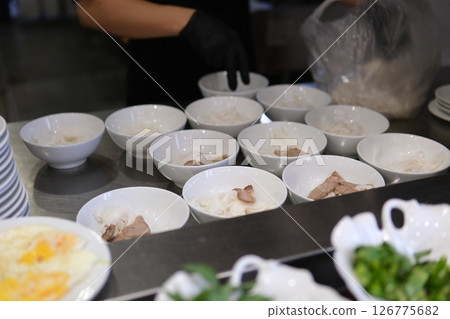 pho soup Vietnamese Vermicelli Soup Making Process Vietnam pho bo seller preparing rice vermicelli soup on the street small eatery cooking fa soup in Vietnam street food dirt unsanitary 126775682
