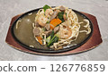 Crispy Ifumie Noodles with Shrimp and Vegetables in Thick Gravy Served on a Hot Plate with Fresh Ingredients on a Wooden Base 126776859
