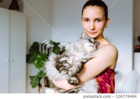 Portrait young woman with pet cat 126778484