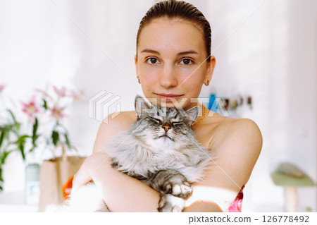 Portrait young woman with pet cat Portrait young woman with pet cat 126778492