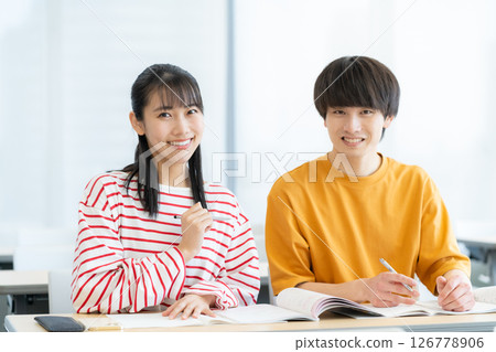 Male and female university students studying. Photo courtesy of Denpa Gakuen Tokyo Electronics College. Male and female university students studying. Photo courtesy of Denpa Gakuen Tokyo Electronics College. 126778906