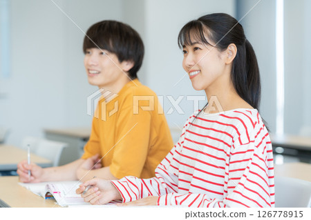 Male and female university students studying. Photo courtesy of Denpa Gakuen Tokyo Electronics College. 126778915