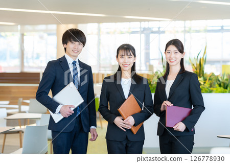 Male and female businessmen having a meeting. Photo courtesy of Denpa Gakuen Tokyo Electronics College. 126778930