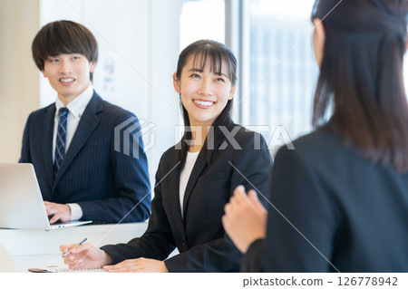 Male and female businessmen having a meeting. Photo courtesy of Denpa Gakuen Tokyo Electronics College. 126778942