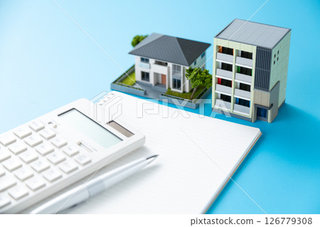 A house, an apartment, a calculator and a notebook A house, an apartment, a calculator and a notebook 126779308
