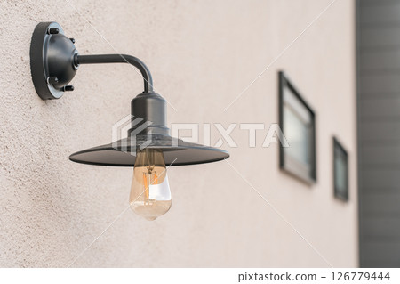 Wall-mounted porch light, bracket light on the exterior wall of a house Wall-mounted porch light, bracket light on the exterior wall of a house 126779444