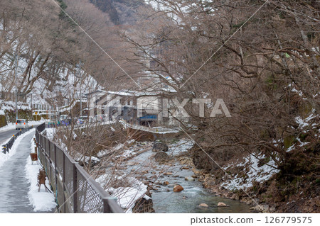 Tochigi, Shima Onsen, snow-covered road along a mountain stream Tochigi, Shima Onsen, snow-covered road along a mountain stream 126779575
