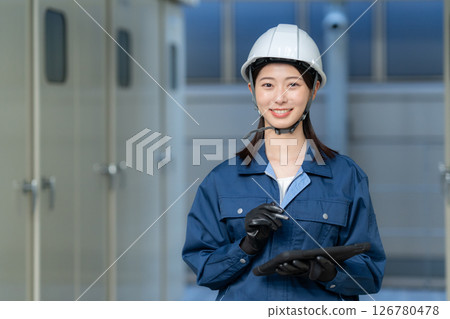 A female engineer performing building maintenance. Photo courtesy of Denpa Gakuen Tokyo Electronics College. A female engineer performing building maintenance. Photo courtesy of Denpa Gakuen Tokyo Electronics College. 126780478