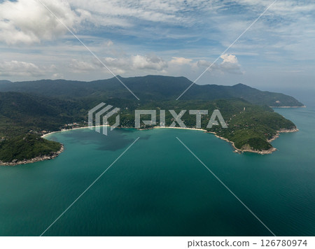 Aerial view of two tropical bays with emerald waters surrounded by lush greenery and mountains. Ko Pha Ngan, Thailand. 126780974
