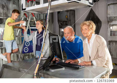 Grandparents and teenagers trying to get out of an escape room stylized under laboratory Grandparents and teenagers trying to get out of an escape room stylized under laboratory 126781069