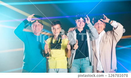 Portrait of happy family after using virtual reality glasses in quest room 126781078