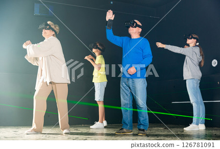 Young boy and girl playing VR games with grandparents Young boy and girl playing VR games with grandparents 126781091