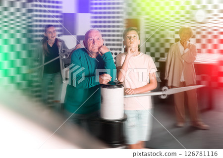 Kids and grandparents thinking about conundrum solution in escape room 126781116