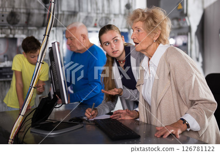 Young girl and boy thinking about riddle solution with their grandparents in escape room. 126781122