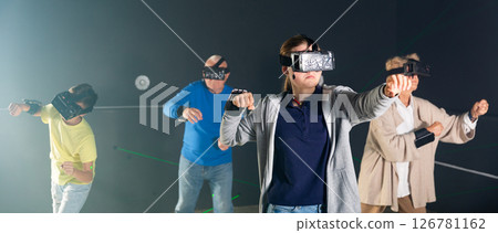 Teenage girl using virtual reality glasses with family 126781162
