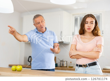 Daughter father scolding and yelling at her in home kitchen 126781174