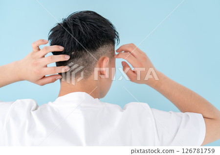 Young man hair care back view Young man hair care back view 126781759