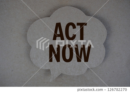 Act Now text with speech bubble on paper craft background 126782270