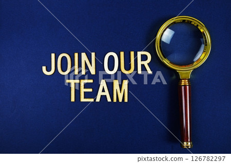 Join Our Team alphabet letters with magnifying glass on navy blue background 126782297