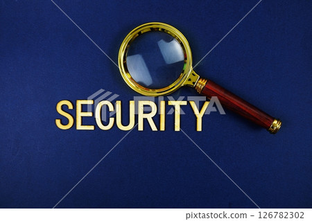 Security alphabet letters with magnifying glass on navy blue background 126782302
