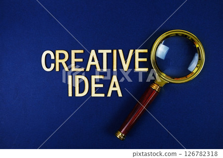 Creative Idea alphabet letters with magnifying glass on navy blue background 126782318