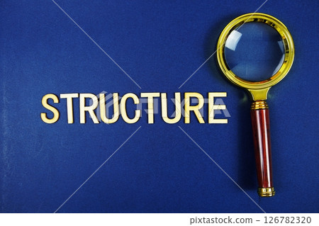 Structure alphabet letters with magnifying glass on navy blue background 126782320