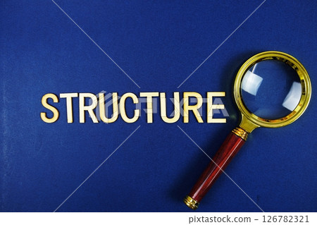 Structure alphabet letters with magnifying glass on navy blue background 126782321