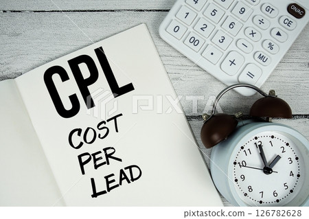 CPL Cost Per Lead text on paper notebook page with alarm clock and calculator on wooden background CPL Cost Per Lead text on paper notebook page with alarm clock and calculator on wooden background 126782628