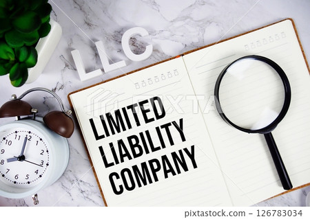 LLC - Limited Liability Company acronym on notepad, Business concept background 126783034
