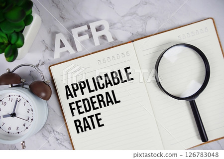 AFR - Applicable Federal Rate acronym on notepad, Business concept background 126783048