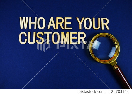Who Are Your Customer? alphabet letters with magnifying glass on navy blue background 126783144