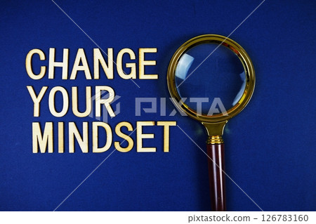 Change Your Mindset alphabet letters with magnifying glass on navy blue background 126783160