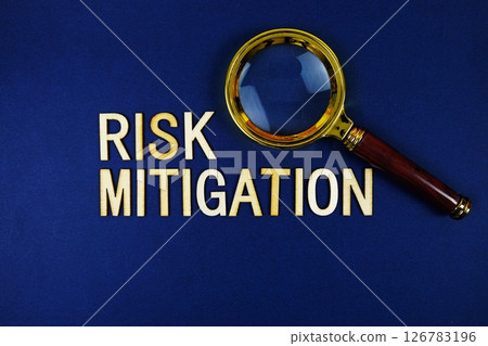 Risk Mitigation alphabet letters with magnifying glass on navy blue background Risk Mitigation alphabet letters with magnifying glass on navy blue background 126783196