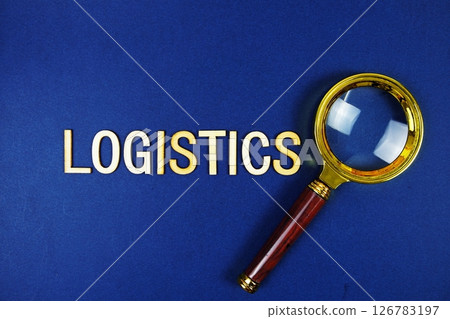 Logistics alphabet letters with magnifying glass on navy blue background 126783197