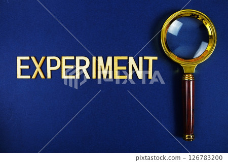 Experiment alphabet letters with magnifying glass on navy blue background Experiment alphabet letters with magnifying glass on navy blue background 126783200