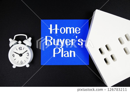 Home Buyers' Plan text with alarm clock and house model on black background Home Buyers' Plan text with alarm clock and house model on black background 126783211
