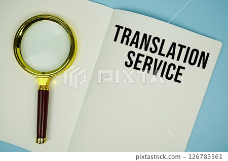 Translation Service text message written on note page with magnifying glass Translation Service text message written on note page with magnifying glass 126783561