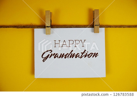 Happy Graduation text on paper card on yellow background 126783588