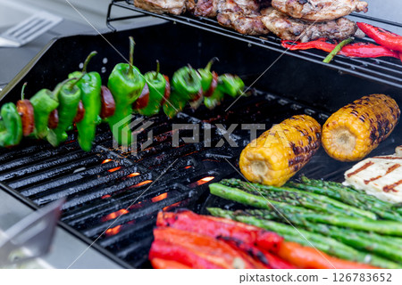 Grilling chicken, corn cobs, paprika, padron, asparagus, meat Grilling chicken, corn cobs, paprika, padron, asparagus, meat 126783652