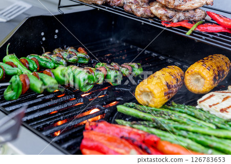 Grilling chicken, corn cobs, paprika, padron, asparagus. Grilling chicken, corn cobs, paprika, padron, asparagus. 126783653