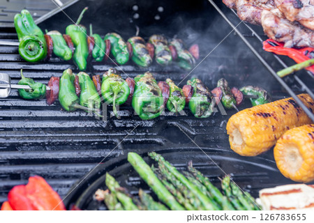 Grilling chicken, corn cobs, paprika, padron, asparagus. Grilling chicken, corn cobs, paprika, padron, asparagus. 126783655