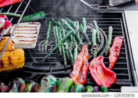 Grilling corn cobs, paprika, padron, asparagus, cheese. 126783656