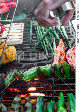 Grilling corn cobs, paprika, padron, asparagus and cheese. 126783657