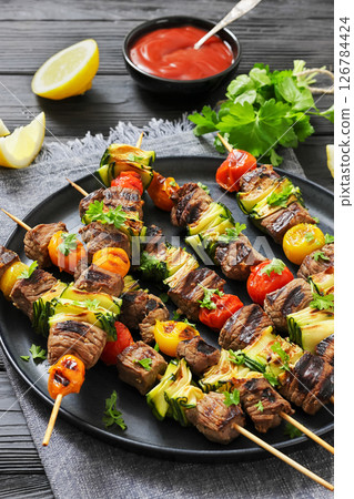 beef kebabs with zucchini and tomatoes on skewers 126784424
