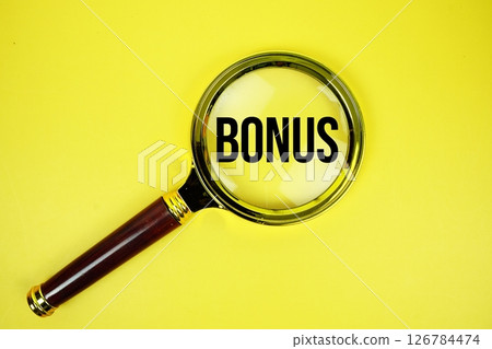 Bonus text with magnifying on yellow background Bonus text with magnifying on yellow background 126784474