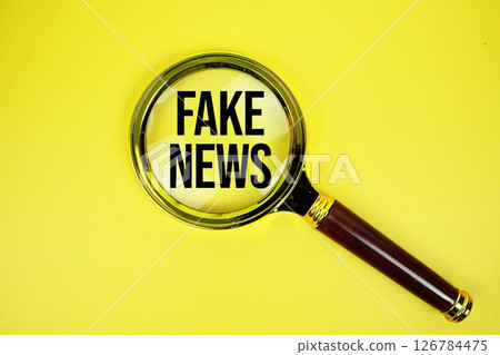 Fake News text with magnifying on yellow background Fake News text with magnifying on yellow background 126784475